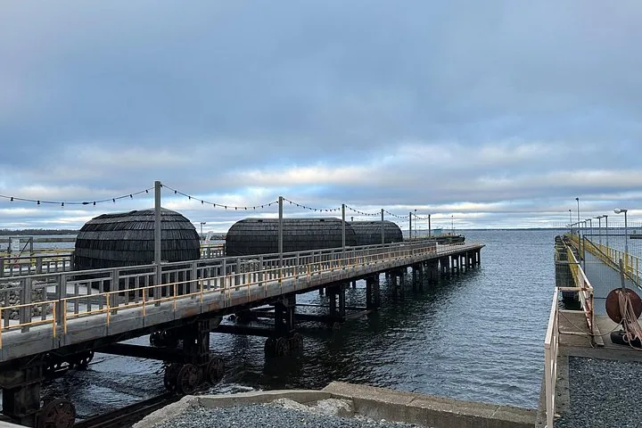 Wooden pier with dome-shaped structures over the water.