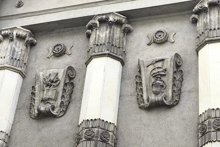 Close-up of building facade with decorative columns and reliefs.
