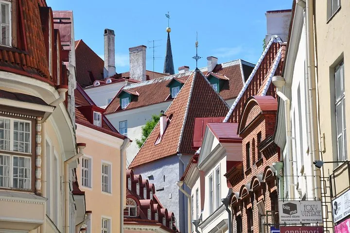 View of colorful rooftops and chimneys in a historic town.