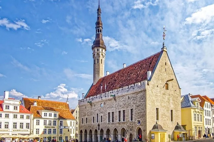 Tallinn Town Hall building with its tall tower in the square.